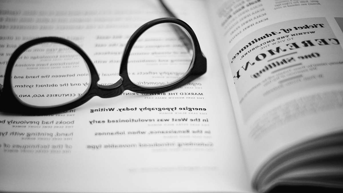 black-and-white black eyeglasses on book body bentonville
